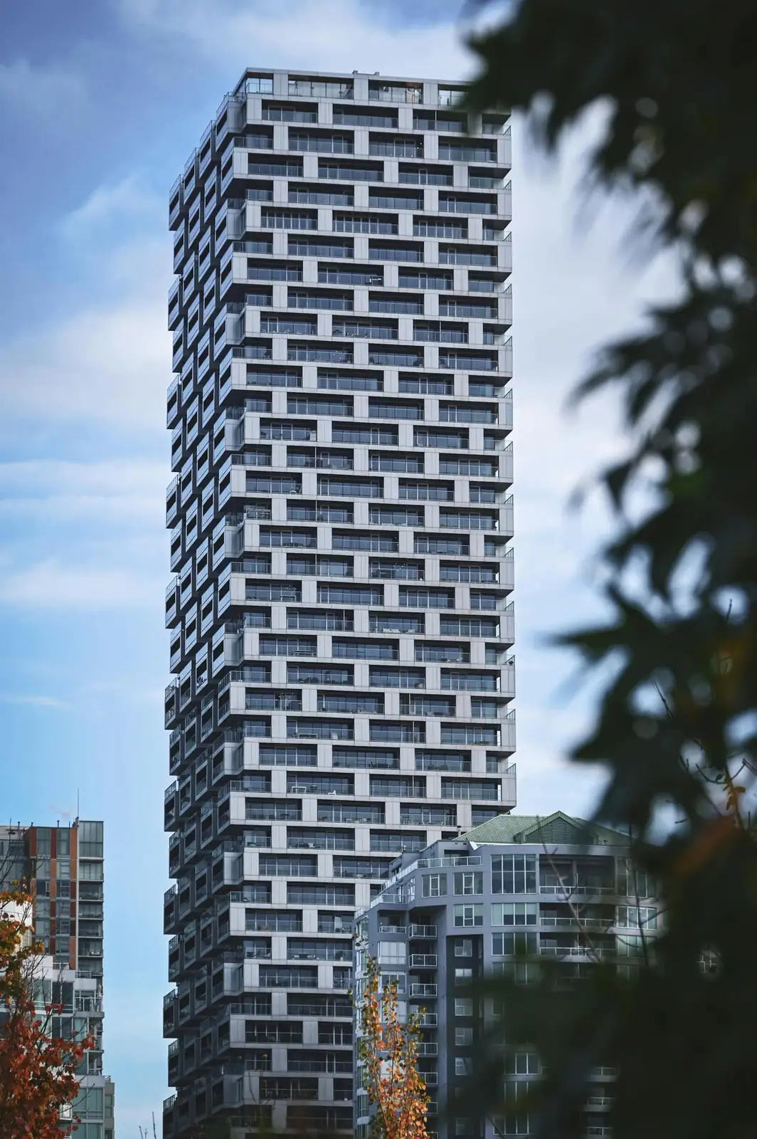 A bright BC residential tower against blue sky