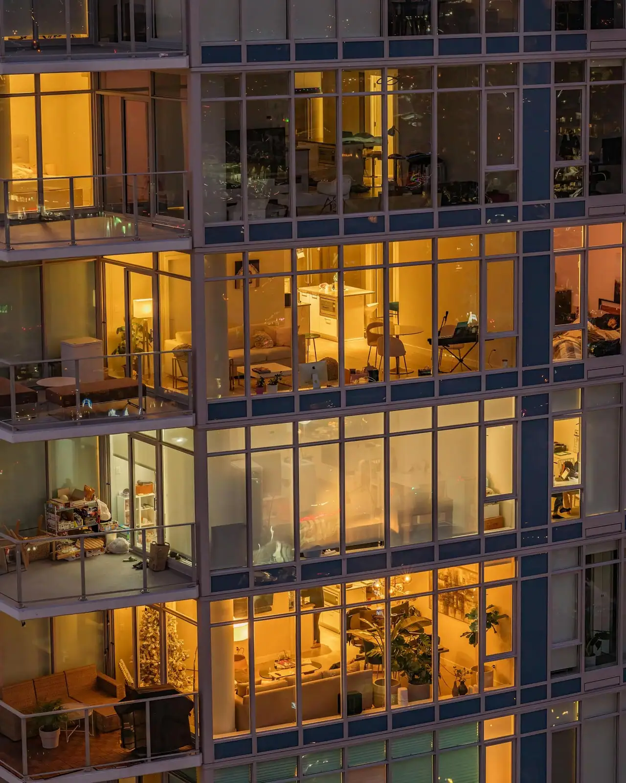 A BC apartment building with lit windows at dusk